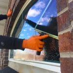 Lakeview Window Cleaning washing a Farmington, Utah window