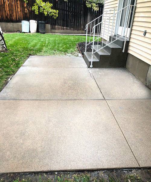 After completion of a concrete patio pressure washing.
