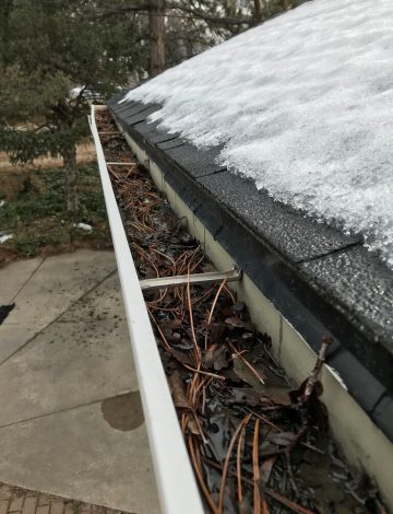 Full, clogged gutters on a home in Bountiful.